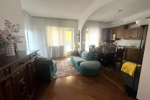 Spacious living room with arch, sofas and parquet floor, La Veranda apartment in Monteverde, Rome